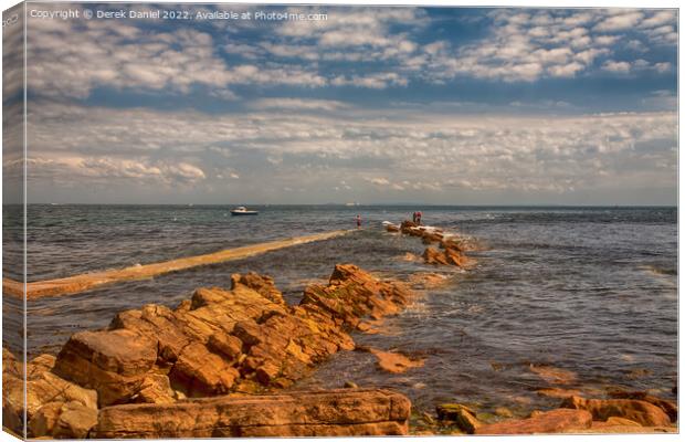 Fishing on the rocks at Peveril Point, Swanage Canvas Print by Derek Daniel