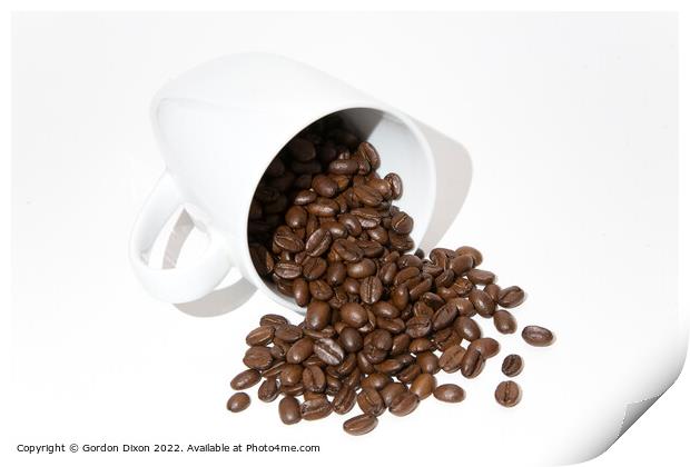 Roasted coffee beans spilling out of a mug - white background Print by Gordon Dixon