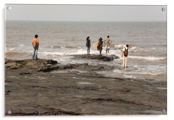 Group of Indian students stand on rocks at Mumbai as the tide comes in Acrylic by Gordon Dixon