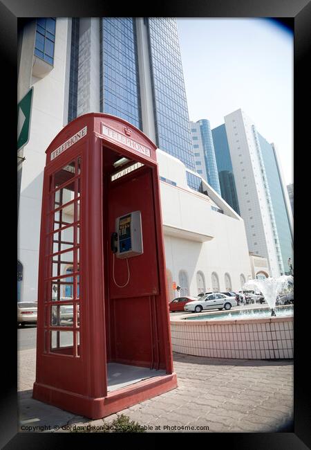 An old British telephone box stood on the pavement in Dubai  Framed Print by Gordon Dixon