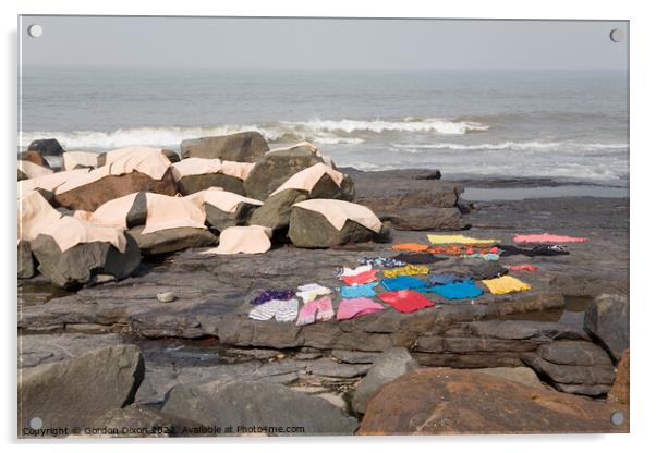 Freshly laundered clothes and fabrics drying on rocks by the sea at Mumbai, India Acrylic by Gordon Dixon