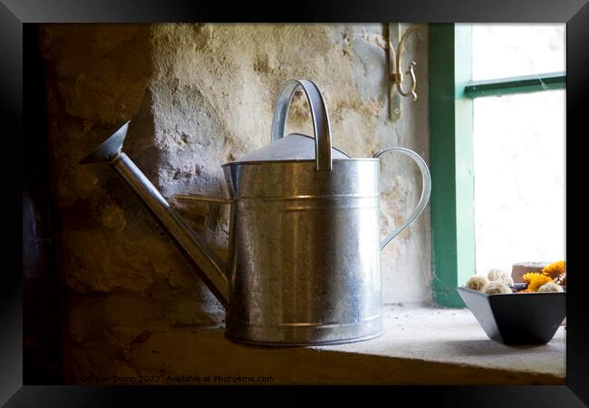 A galvanised watering can sits on a windowsill Framed Print by Gordon Dixon