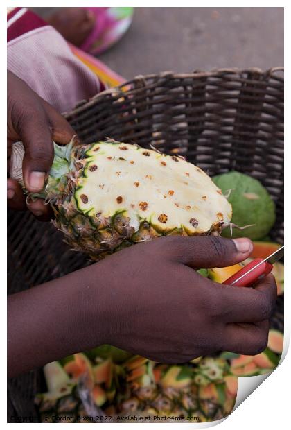 Preparing a pineapple for eating - roadside seller, Ghana Print by Gordon Dixon