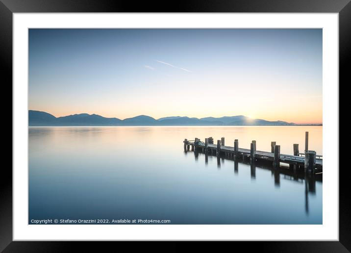 Wooden pier at sunrise. Lake Massaciuccoli Framed Mounted Print by Stefano Orazzini