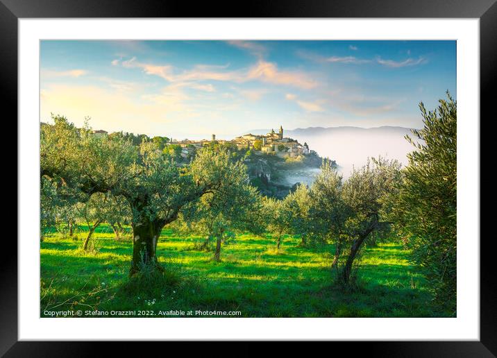 Trevi picturesque village and olive trees in a foggy morning. Framed Mounted Print by Stefano Orazzini