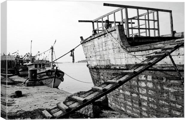 Wooden ship undergoing repairs in Mangalore - watercolour conversion of B&W image Canvas Print by Gordon Dixon