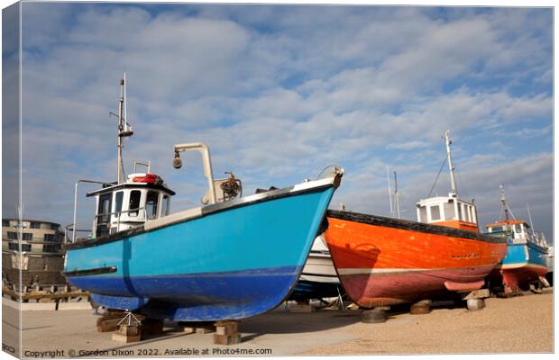 Orange and blue fishing trawlers on quay in winter Canvas Print by Gordon Dixon