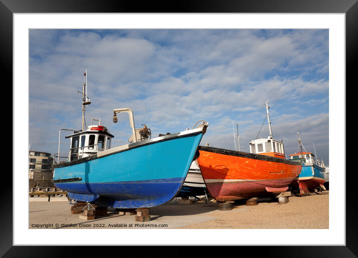 Orange and blue fishing trawlers on quay in winter Framed Mounted Print by Gordon Dixon