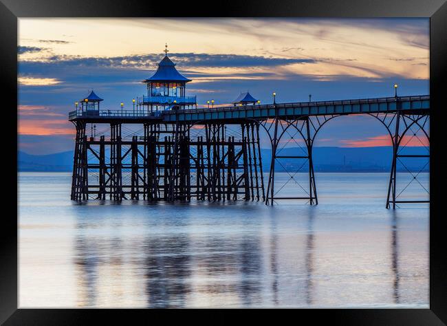 Clevedon Pier at sunset with reflection Framed Print by Rory Hailes