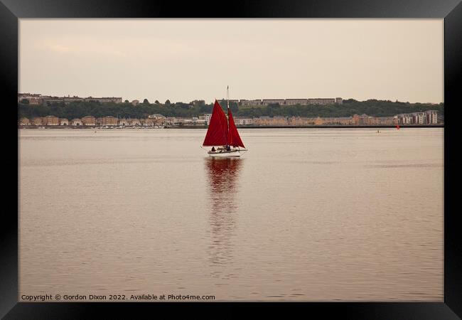 Yacht with red sails set approaches Cardiff Bay, South Wales Framed Print by Gordon Dixon