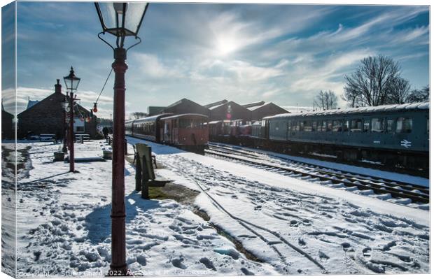 Locomotives on a snow-covered station platform Canvas Print by Stuart Chard