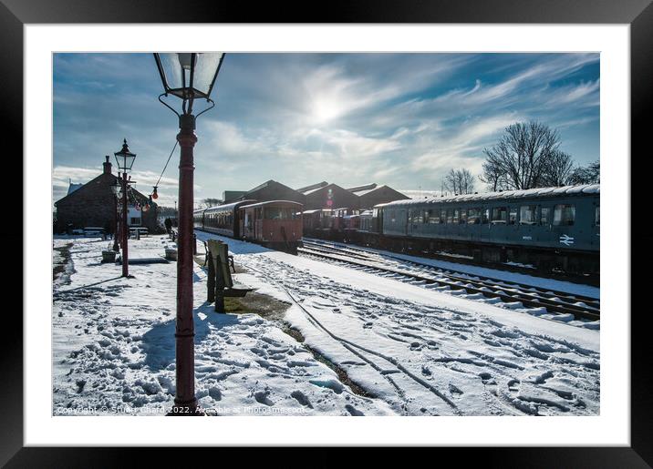 Locomotives on a snow-covered station platform Framed Mounted Print by Stuart Chard