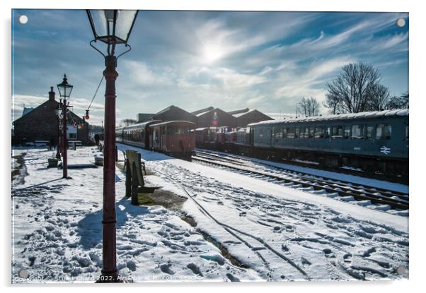 Locomotives on a snow-covered station platform Acrylic by Travel and Pixels 
