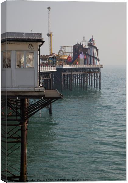 Brighton pier amusements - funfair over the sea Canvas Print by Gordon Dixon