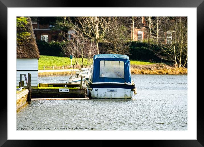A small boat moored alongside a wooden boat house with a thatched roof on the River Bure in Coltishall, Norfolk Broads Framed Mounted Print by Chris Yaxley