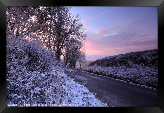 A quiet country road on a snowy morning with a colourful sinrise Framed Print by Angela Redrupp
