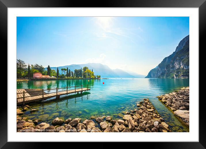 Wooden pier on the lake. Riva del Garda, Italy Framed Mounted Print by Stefano Orazzini