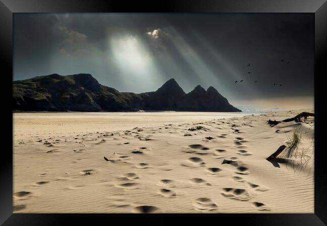 Shafts of light over Three Cliffs Bay Framed Print by Leighton Collins