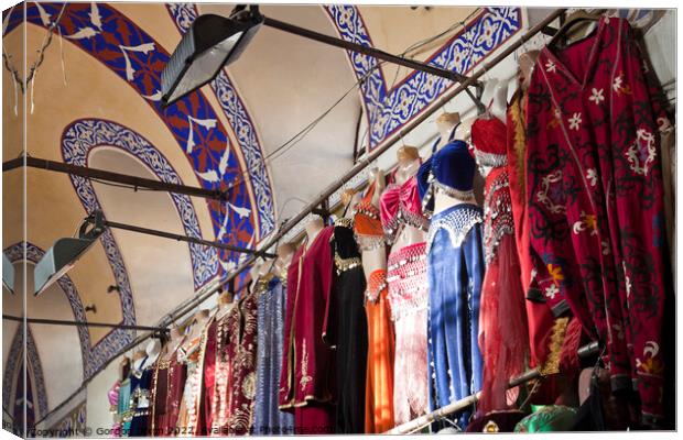 Clothing stall inside Istanbul's ornate Grand Bazzar Canvas Print by Gordon Dixon