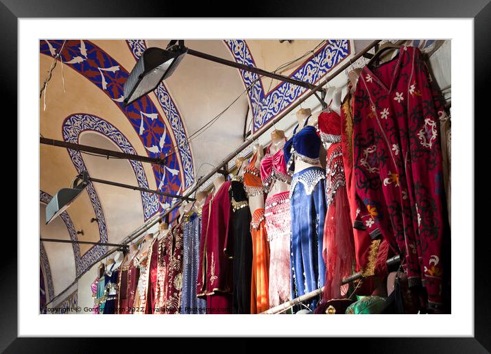 Clothing stall inside Istanbul's ornate Grand Bazzar Framed Mounted Print by Gordon Dixon