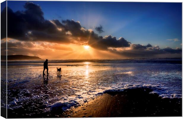 A dog walker at Widemouth Bay, Bude Cornwall. Canvas Print by Maggie McCall