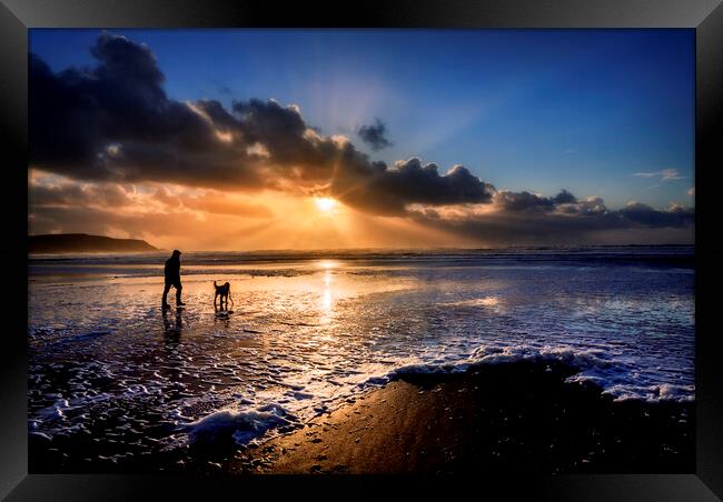 A dog walker at Widemouth Bay, Bude Cornwall. Framed Print by Maggie McCall