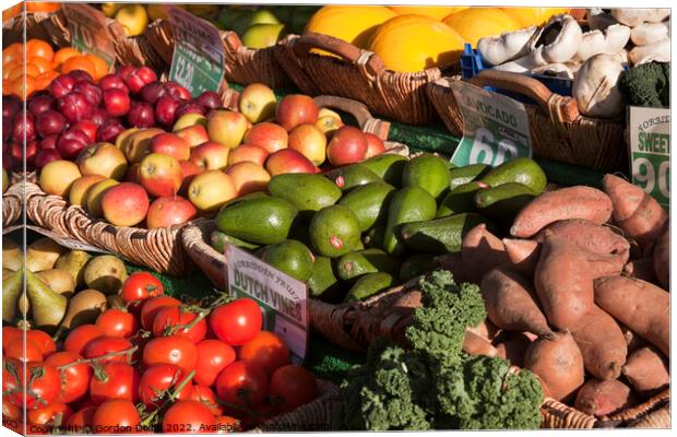 Bright colourful selection of 12 fresh fruit and vegetables on market stall Canvas Print by Gordon Dixon