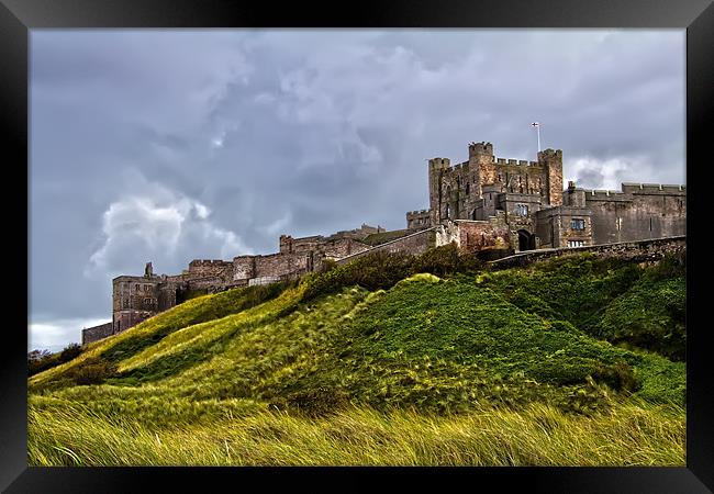 Bamburgh Castle Stormy Skies Framed Print by Northeast Images