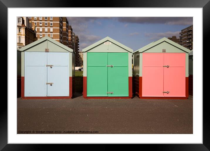 Three beach huts in pastel shades - Brighton Framed Mounted Print by Gordon Dixon