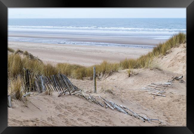 Fallen fence leading down to Formby beach Framed Print by Jason Wells