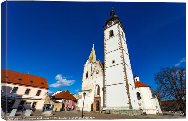 Gothic church of the Nativity of the Blessed Virgin Mary and clock tower. Pisek - town in South Czechia. Canvas Print by Sergey Fedoskin