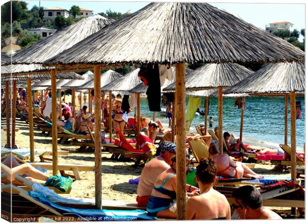 Busy Achladia Beach, Skiathos, Greece. Canvas Print by john hill