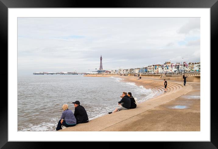 Tourists sit on Blackpool seafront Framed Mounted Print by Jason Wells