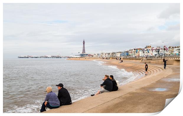 Tourists sit on Blackpool seafront Print by Jason Wells