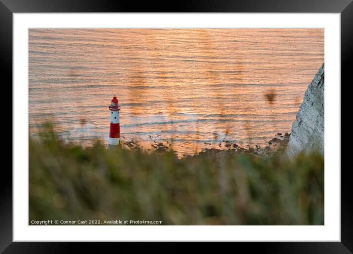 Lighthouse through the grass  Framed Mounted Print by Connor Cast