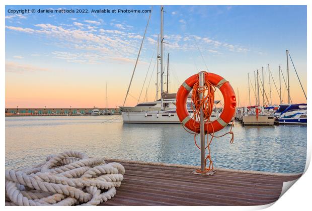 the quay of a marina at  the sunset Print by daniele mattioda