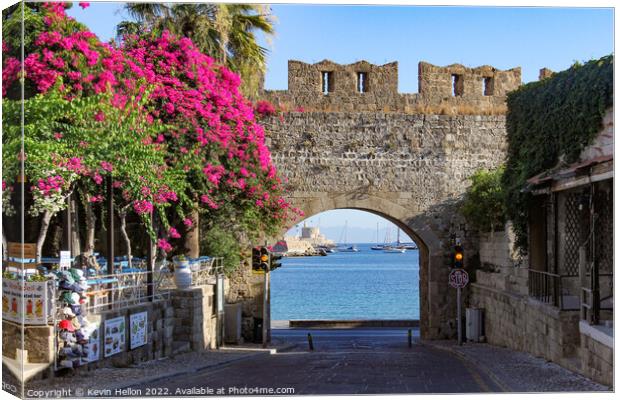 Looking through a gateway to the harbour, Rhodes Town, Greece Canvas Print by Kevin Hellon