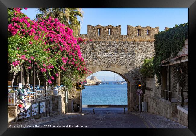 Looking through a gateway to the harbour, Rhodes Town, Greece Framed Print by Kevin Hellon