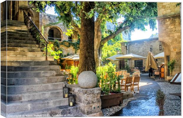 Sunny courtyard in Rhodes Town, Greece Canvas Print by Kevin Hellon