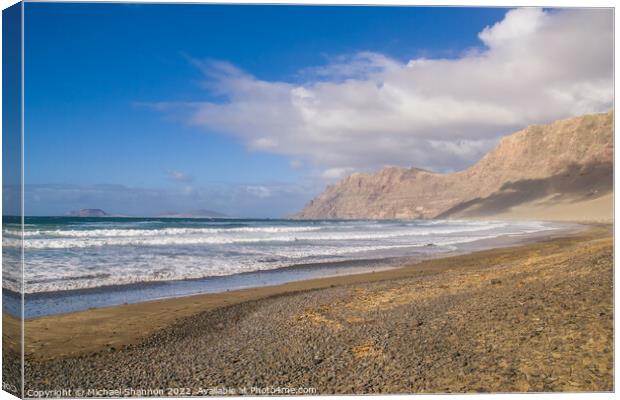 The beach and cliffs at Famara, Lanzarote Canvas Print by Michael Shannon