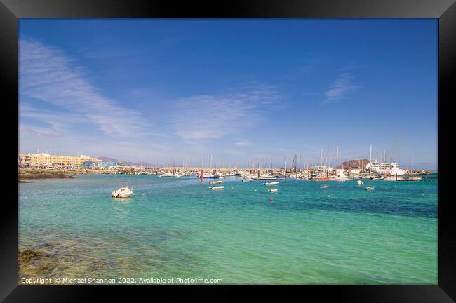 Small boats moored in the bay, next to the harbour Framed Print by Michael Shannon