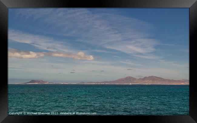 Looking across the sea from Fuerteventura to Playa Framed Print by Michael Shannon