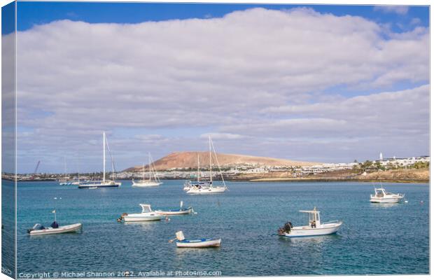 Small boats and Playa Blanca resort, Lanzarote Canvas Print by Michael Shannon