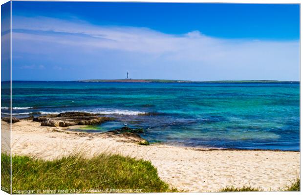 Deserted sandy beach at Punta Prima looking out to lighthouse on Canvas Print by Mehul Patel