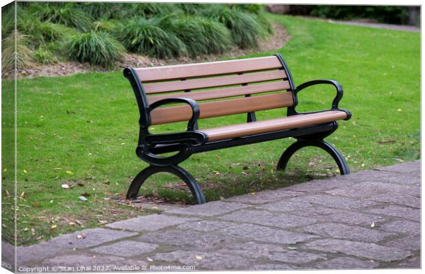 Brown bench in the park Canvas Print by Stan Lihai