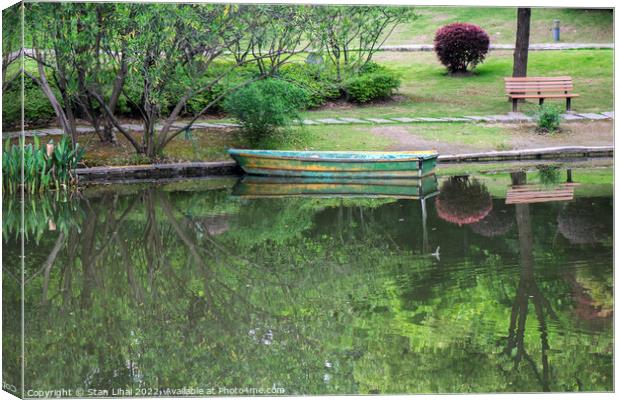 Old wooden boat on the lake Canvas Print by Stan Lihai