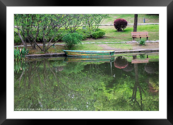 Old wooden boat on the lake Framed Mounted Print by Stan Lihai
