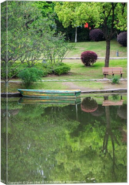 Old wooden boat on the lake Canvas Print by Stan Lihai