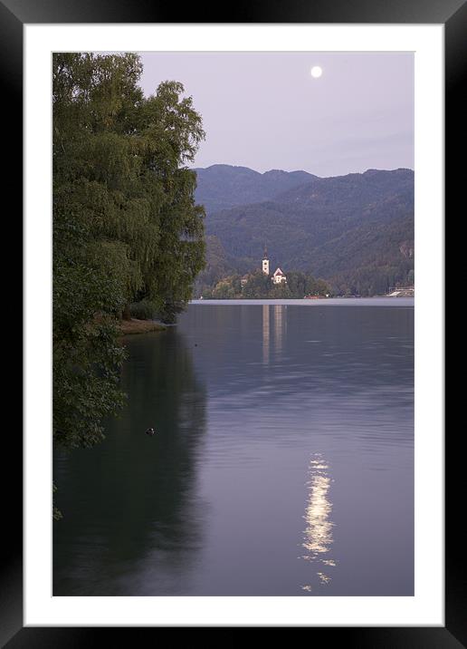 Moon setting at sunrise over Island church at Lake Framed Mounted Print by Ian Middleton