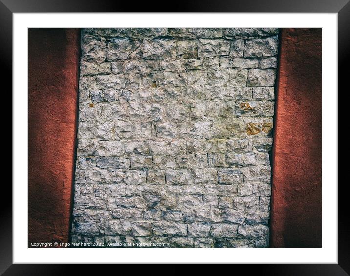 Crooked and abstract old brick wall between red concrete Framed Mounted Print by Ingo Menhard